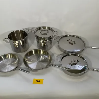 Sale Photo Thumbnail #23: All-Clad stainless steel cookware set, including frying pans, a stockpot, a double boiler insert, and lidded skillets, showing light wear.