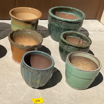 Sale Photo Thumbnail #8: Collection of six glazed ceramic garden planters in various shades of green, brown, and blue, featuring textured rims and ribbed details.