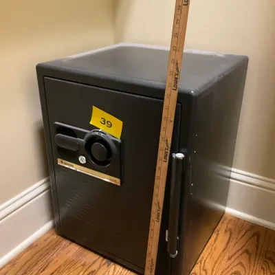 Sale Photo Thumbnail #15: Sentry model A5880 fire-safe with a combination lock and key entry, shown with a yardstick for scale.