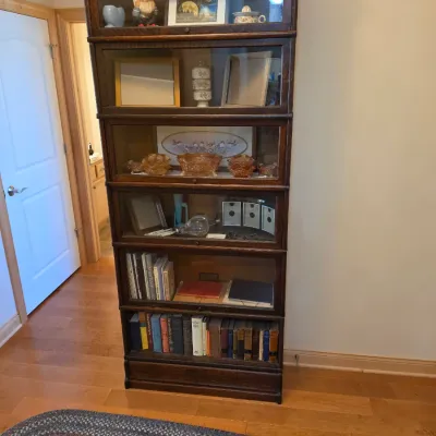 Sale Photo Thumbnail #4: Antique oak barrister bookcase with six glass-front stacking sections, displaying books and various collectibles.