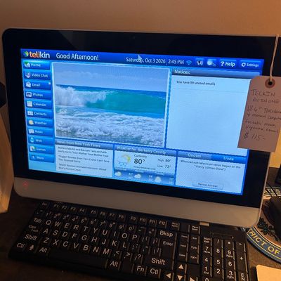 Sale Photo Thumbnail #59: Telikin All-in-One computer featuring an 18.6-inch touchscreen, designed with a simplified interface for seniors, shown powered on with its matching keyboard.
