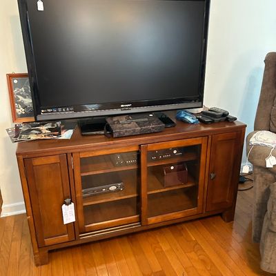 Sale Photo Thumbnail #84: TV stand with glass doors. 