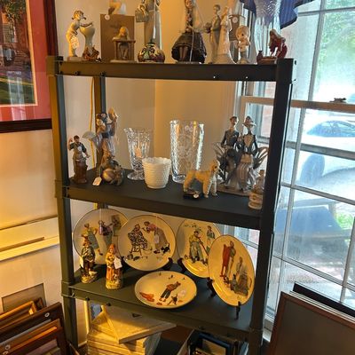 Sale Photo Thumbnail #8: A collection of vintage Lladro porcelain figurines, crystal vases, and Norman Rockwell collector plates. 