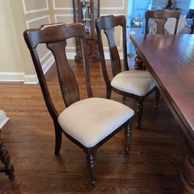 Sale Photo Thumbnail #35: Set of traditional dark wood dining chairs featuring vasiform splat backs, turned front legs, and cream upholstered seats.