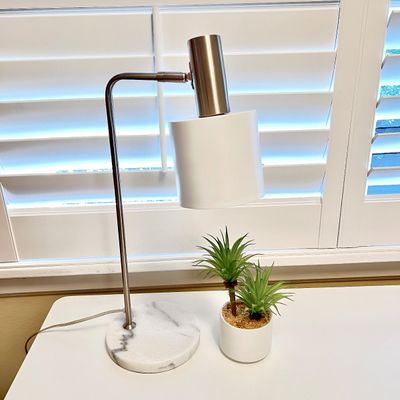 Sale Photo Thumbnail #106: Modern brushed nickel desk lamp featuring a round white marble base and a cylindrical white shade.
