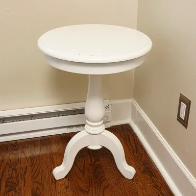Sale Photo Thumbnail #76: White painted wooden pedestal accent table with a round top and tripod cabriole legs.