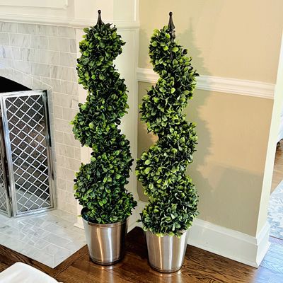 Sale Photo Thumbnail #16: Pair of spiral artificial topiary potted plants in polished silver-tone containers.