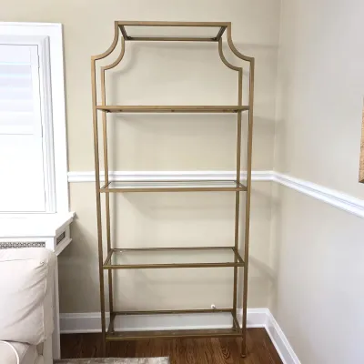 Sale Photo Thumbnail #116: Tall brass-toned metal etagere shelving unit with glass shelves and a curved Pagoda-style top, in clean condition.