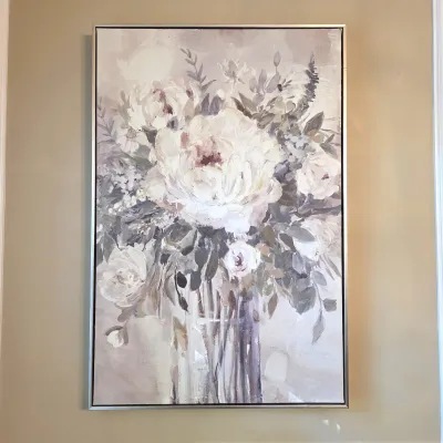 Sale Photo Thumbnail #42: Large contemporary floral canvas painting featuring soft cream and grey flowers in a glass vase, framed in a thin silver metallic frame.