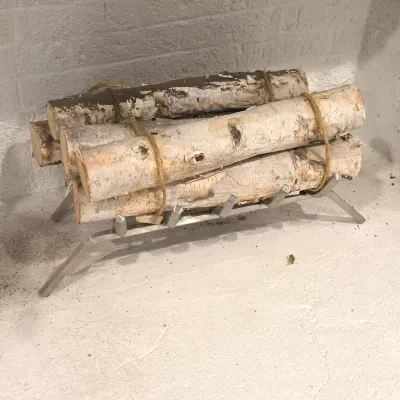 Sale Photo Thumbnail #50: Modern silver-tone fireplace grate holding a decorative bundle of birch logs wrapped in twine.