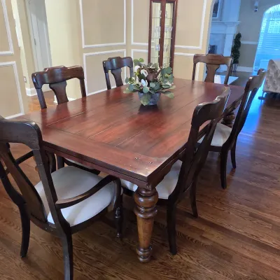 Sale Photo Thumbnail #34: Traditional dark wood dining set including a rectangular table with turned legs and six matching dining chairs with upholstered seats.