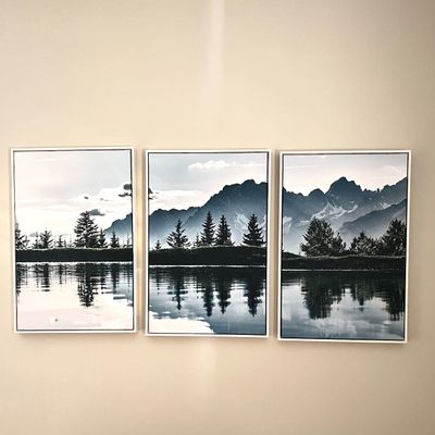 Sale Photo Thumbnail #97: Three-piece framed triptych wall art featuring a black-and-white monochromatic photographic print of a mountain landscape reflected in water.