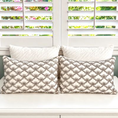 Sale Photo Thumbnail #132: Set of decorative throw pillows, featuring a pair with intricate gray beaded scallop patterns and a pair of white textured square pillows.