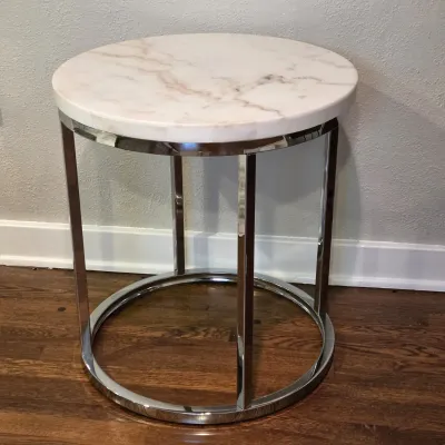 Sale Photo Thumbnail #62: Modern round side table featuring a polished white marble top with subtle grey and tan veining, supported by a polished chrome metal frame.