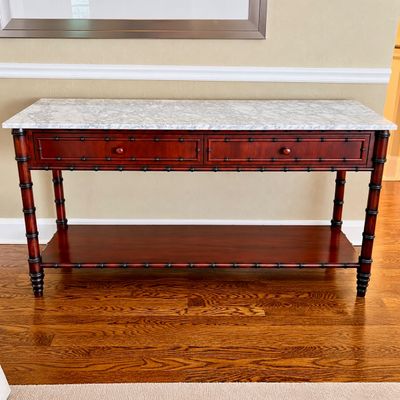Sale Photo Thumbnail #4: William Sonoma Faux bamboo mahogany console table featuring a grey-veined white marble top, two drawers, and a lower display shelf.