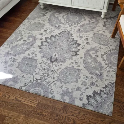 Sale Photo Thumbnail #29: Large grey and cream floral damask area rug displayed on a dark hardwood floor.