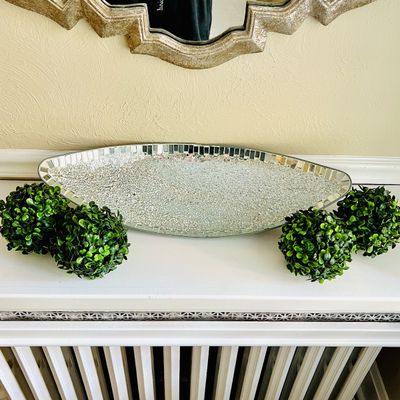 Sale Photo Thumbnail #17: Glam-style crushed glass and mirror-mosaic decorative boat-shaped tray displayed with four artificial green boxwood topiary balls.