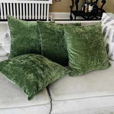 Sale Photo Thumbnail #22: Set of four plush olive green textured velvet throw pillows arranged on a sofa.