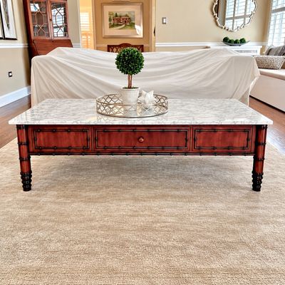 Sale Photo Thumbnail #18: Faux-bamboo wood coffee table featuring a white marble top, decorative drawer fronts, and turned legs.