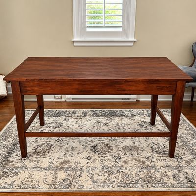 Sale Photo Thumbnail #98: Solid wood counter-height table or desk with a rich reddish-brown stain and lower crossbar stretchers.