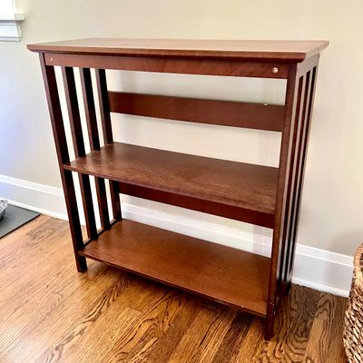 Sale Photo Thumbnail #94: Mission-style dark wood low bookcase with slotted side panels and two open shelves.