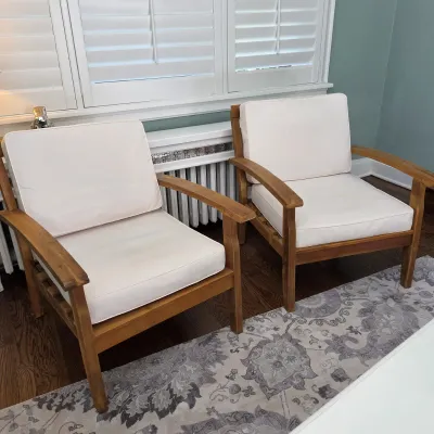 Sale Photo Thumbnail #24: Pair of contemporary teak armchair patio seats with off-white fabric cushions.