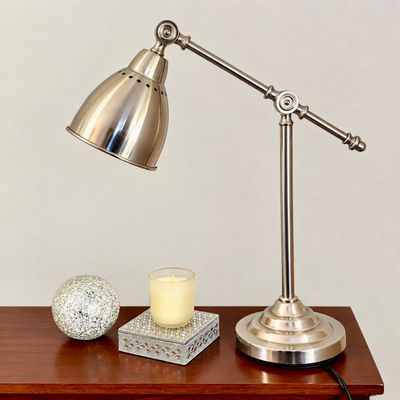Sale Photo Thumbnail #93: Brushed nickel adjustable swing-arm desk lamp with a bell shade, displayed alongside a mosaic orb and decorative candle.