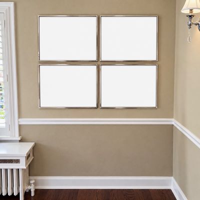 Sale Photo Thumbnail #12: Set of four matching silver-toned picture frames arranged in a two-by-two grid on a neutral wall.