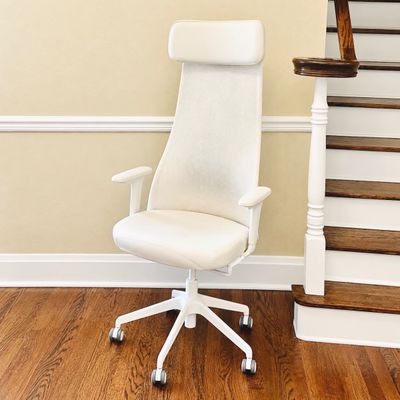 Sale Photo Thumbnail #107: Modern white ergonomic high-back desk chair featuring a mesh backrest, padded headrest, adjustable armrests, and a five-star wheeled base.
