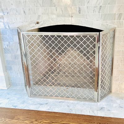 Sale Photo Thumbnail #15: Modern silver-toned three-panel folding fireplace screen featuring an ornate lattice wire mesh design.