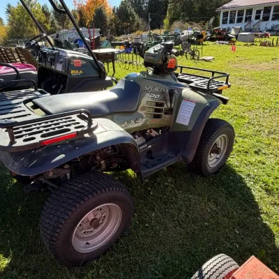 Sale Photo Thumbnail #13: Polaris Sportsman 500 4x4 ATV in olive green, featuring front and rear cargo racks