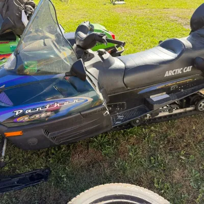 Sale Photo Thumbnail #18: Arctic Cat Panther 440 snowmobile, featuring a two-up seat with backrest, windshield, and classic teal and purple graphics.