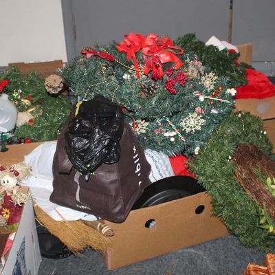 Sale Photo Thumbnail #58: Assorted holiday decorations, including artificial Christmas wreaths, a grapevine wreath, and scarecrow dolls, packed in cardboard boxes.