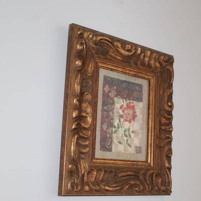 Sale Photo Thumbnail #30: Framed floral print featuring a single red flower, housed in an ornate, heavily carved gold-finished frame.