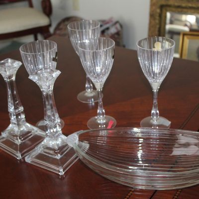 Sale Photo Thumbnail #87: Assorted clear glassware including a pair of pressed glass candlesticks, four ribbed wine goblets, and an oval ribbed glass serving dish.