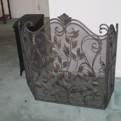 Sale Photo Thumbnail #35: Three-panel wrought iron fireplace screen featuring a decorative leaf and vine motif with scrollwork details.