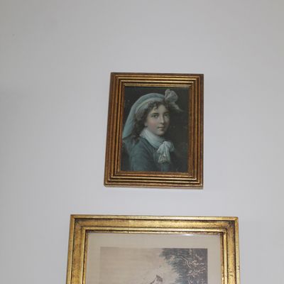 Sale Photo Thumbnail #24: Two framed vintage portraits in ornate gold-finished frames, featuring classical-style depictions of young women.