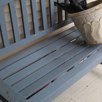 Sale Photo Thumbnail #4: Weathered blue-gray painted wooden garden bench with a slatted seat and backrest, showing some wear and paint chipping.