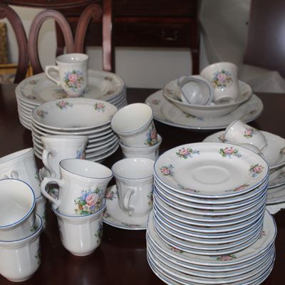 Sale Photo Thumbnail #86: Vintage porcelain dinnerware set featuring delicate floral patterns and blue trim, including plates, bowls, cups, and saucers.