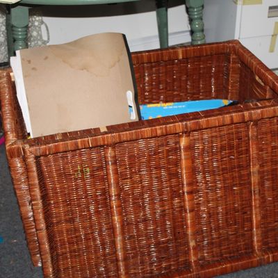 Sale Photo Thumbnail #54: Large rectangular woven wicker storage basket in a warm brown finish, containing miscellaneous items.