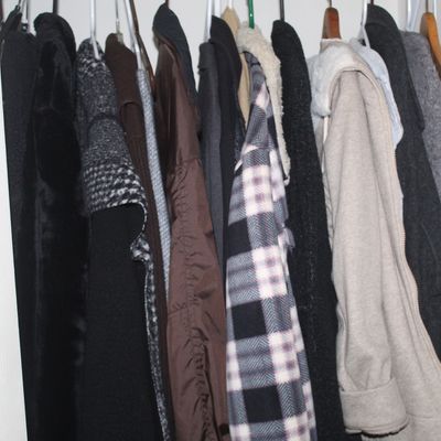 Sale Photo Thumbnail #37: Assortment of winter coats and jackets, including wool, plaid, and fleece-lined styles, hanging in a closet.