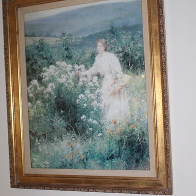 Sale Photo Thumbnail #116: Impressionistic framed print depicting a woman in a white dress gathering flowers in a field, housed in an ornate gilt wood frame.