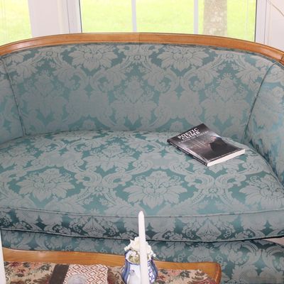 Sale Photo Thumbnail #73: Vintage French Provincial style settee featuring a curved wood frame and teal damask upholstery.
