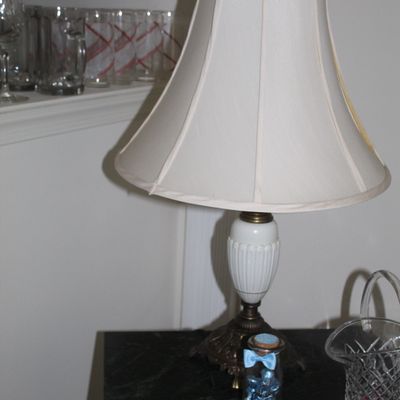 Sale Photo Thumbnail #64: Vintage table lamp featuring a white ribbed glass urn body, an ornate brass-finished base, and a cream-colored fabric bell shade.