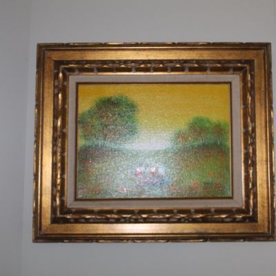 Sale Photo Thumbnail #39: Impressionist-style landscape oil painting depicting a grassy field with trees under a yellow sky, housed in an ornate, multi-tiered gilt wood frame.