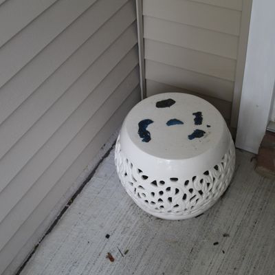 Sale Photo Thumbnail #3: White ceramic garden stool featuring openwork lattice detailing and dark blue glazed accents on the top surface.