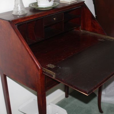 Sale Photo Thumbnail #80: Vintage mahogany slant-front secretary desk featuring a drop-down writing surface, interior cubbies, and slender cabriole legs.