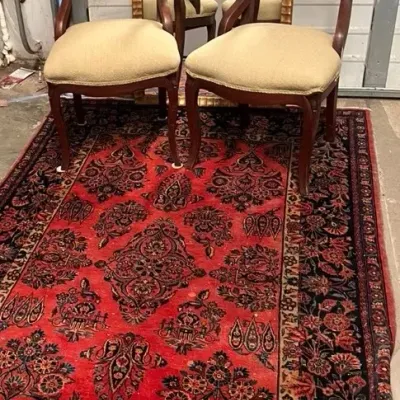 Vintage persian style red rug with pair of chairs mirror