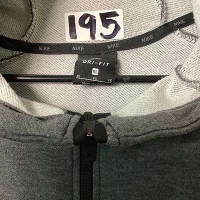 Sale Photo Thumbnail #530: Men's Nike Dri-FIT full zip hoodie in dark gray heather. Features embroidered Nike swoosh logo on the left chest, front hand pockets, and raglan sleeves. Size XL Pre-owned in good condition with light overall wear, no major stains or tears observed.