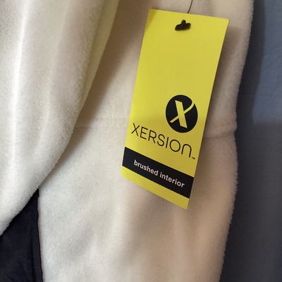 Sale Photo Thumbnail #428: New with tags Xersion quarter-zip fleece pullover in ivory with black trim and accent pocket. Features brushed interior fleece fabric, thumbholes, center zip pocket, and no-chafe seams. Size XXL.